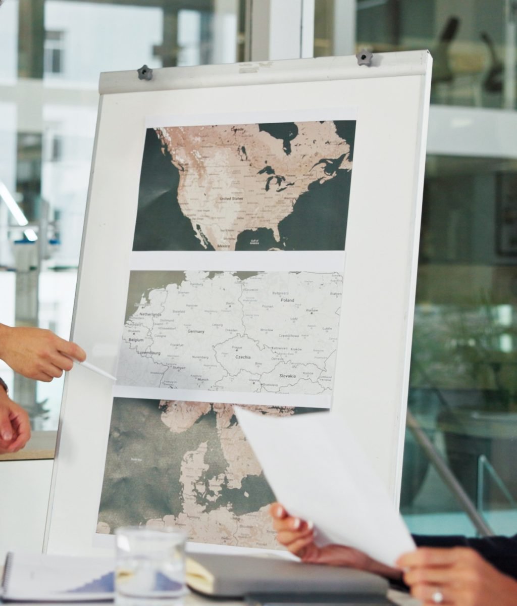 Presentation, business man and map on whiteboard for weather pattern, target market and marketing geography. Screen, meeting and team speaker in office with climate data for planning global campaign