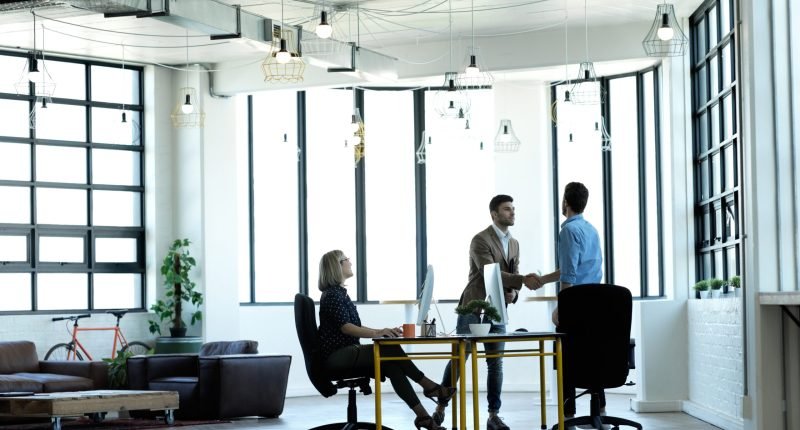 Business meeting, handshake and accounting company collaboration at workplace for finance deal, b2b work partnership and working accountants with thank you hand gesture for crm contract discussion.
